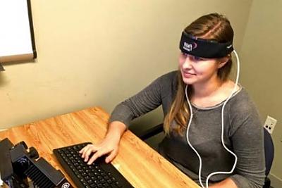 A student participates in a neuroimaging (fNIRS) study in a LCIRT research lab. 